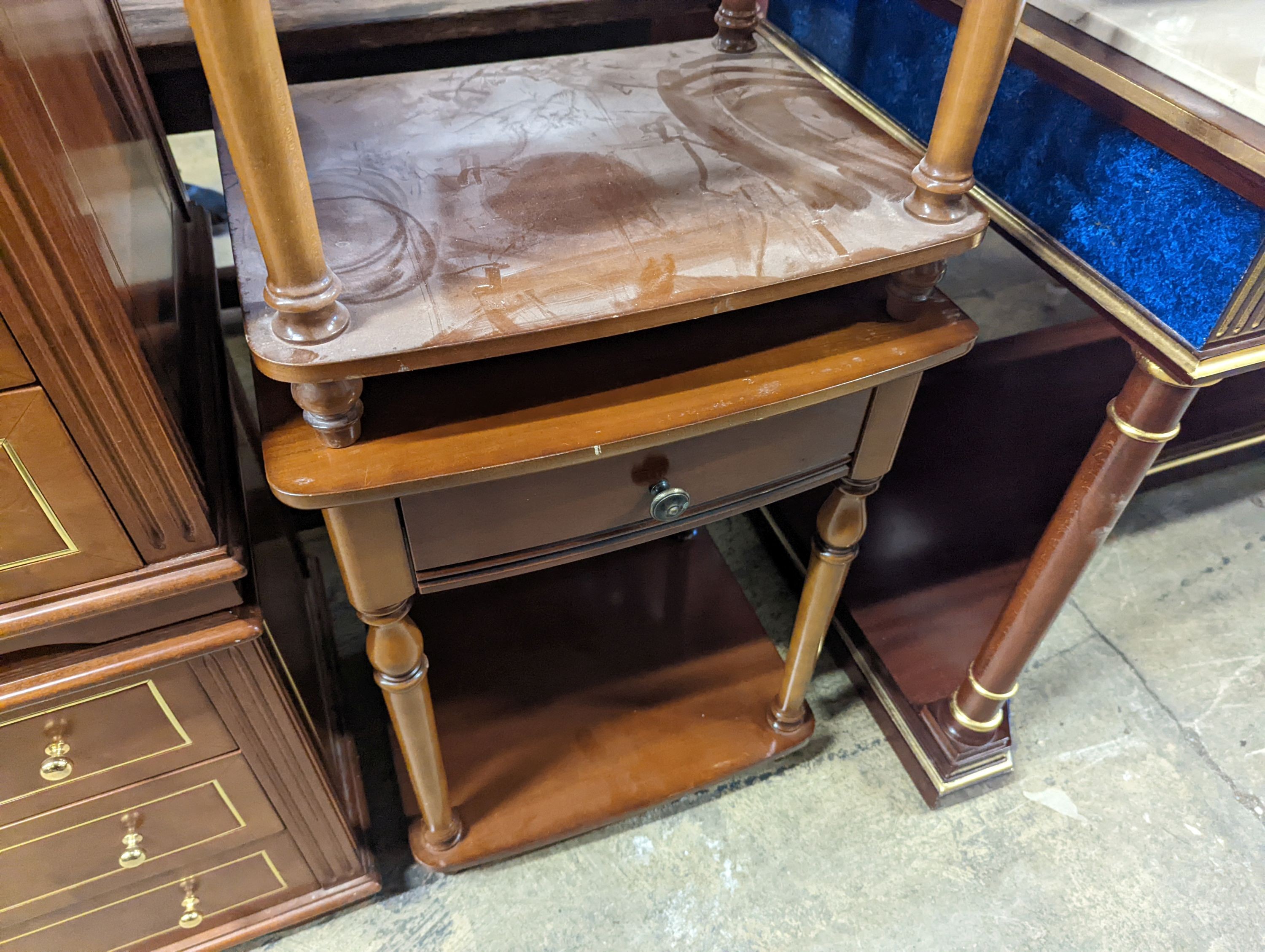 A pair of walnut bow front two tier bedside tables, width 47cm, depth 38cm, height 72cm